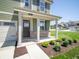 Inviting entryway with a covered porch and manicured landscaping at 8703 Duncan St, Fortville, IN 46040