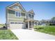 Beautiful two-story home featuring a spacious driveway, lush lawn, and inviting entryway at 8703 Duncan St, Fortville, IN 46040