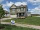 Charming two-story home with manicured lawn and for sale sign at 8703 Duncan St, Fortville, IN 46040