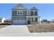 Two-story home with a two-car garage, manicured lawn, and welcoming front porch at 8703 Duncan St, Fortville, IN 46040