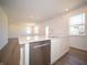 Open concept kitchen with island, stainless steel dishwasher, and seamless flow into the living area at 8703 Duncan St, Fortville, IN 46040