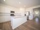 Modern kitchen with stainless appliances, a central island, and ample white cabinetry offering abundant storage at 8703 Duncan St, Fortville, IN 46040