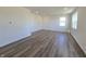 Spacious living room with hardwood floors and large windows, providing ample natural light at 8703 Duncan St, Fortville, IN 46040