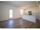 Bright living area open to the kitchen, featuring white cabinetry, stainless steel appliances, and modern finishes at 8703 Duncan St, Fortville, IN 46040