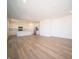 Spacious living area showcasing modern lighting, and an open flow into the kitchen with stainless appliances at 8703 Duncan St, Fortville, IN 46040