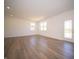 Bright living room featuring recessed lighting, beautiful hardwood floors, and abundant natural light at 8703 Duncan St, Fortville, IN 46040