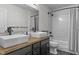 Modern bathroom with double sinks, subway tile, and a wood countertop at 8841 Weather Stone Xing, Zionsville, IN 46077