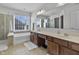 Main bathroom with double vanity, soaking tub, and walk-in shower at 8841 Weather Stone Xing, Zionsville, IN 46077