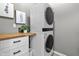 Laundry room with stackable washer and dryer and butcher block countertop at 8841 Weather Stone Xing, Zionsville, IN 46077