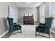 Living Room with two green velvet armchairs and a piano at 8841 Weather Stone Xing, Zionsville, IN 46077