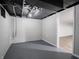 Unfinished basement room with grey flooring and white cinderblock walls at 935 S Morgantown Rd, Greenwood, IN 46143