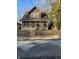 Two-story house with brown siding and a screened porch at 1420 W 23Rd St, Indianapolis, IN 46208