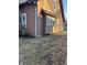Side view of a brown house with a window and downspout at 1420 W 23Rd St, Indianapolis, IN 46208