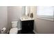 Cozy powder room featuring a black vanity, white toilet, and modern fixtures at 15540 Starflower Dr, Westfield, IN 46074