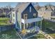 Modern home with gray and black exterior, balcony, and landscaped yard at 1948 Central Ave, Indianapolis, IN 46202