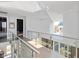 Modern glass-railed hallway with views to the kitchen below at 1948 Central Ave, Indianapolis, IN 46202