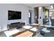 Bright living room with hardwood floors, large TV, and comfortable seating at 1948 Central Ave, Indianapolis, IN 46202