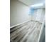 Simple bedroom with gray walls and gray vinyl plank flooring at 2119 Noble St, Anderson, IN 46016