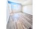 Spacious bedroom with wood-look flooring and large window at 2119 Noble St, Anderson, IN 46016