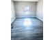 Bright living room featuring gray walls and gray plank flooring at 2119 Noble St, Anderson, IN 46016