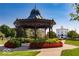 Beautifully landscaped community gazebo with surrounding green space and manicured flower beds at 2207 Glebe St, Carmel, IN 46032