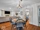 Cozy dining room with wood floors, stylish lighting, and a view into the living area at 2224 Boston Ct # A, Indianapolis, IN 46228