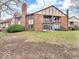 A charming exterior view of a brick townhome, showcasing a balcony and sliding glass doors at 2224 Boston Ct # A, Indianapolis, IN 46228