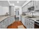Well-lit kitchen featuring granite counters, gray cabinets, and stainless steel appliances at 2224 Boston Ct # A, Indianapolis, IN 46228
