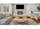 Comfortable living room with a fireplace, soft lighting, and large windows at 2224 Boston Ct # A, Indianapolis, IN 46228