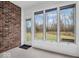 Bright sun room with brick wall and large windows overlooking the backyard and trees at 2224 Boston Ct # A, Indianapolis, IN 46228