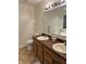 Clean bathroom with double sinks, wood cabinets, and a large mirror at 2322 Bainbridge Rd, Greenwood, IN 46143