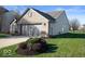 Side view of ranch home showcasing garage and landscaping at 2322 Bainbridge Rd, Greenwood, IN 46143