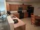 Eat-in kitchen with oak cabinets, black appliances, and dining area at 2322 Bainbridge Rd, Greenwood, IN 46143