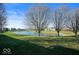 Serene pond view with lush green space and mature trees at 2322 Bainbridge Rd, Greenwood, IN 46143