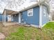 A view of the home's backyard, showing the covered patio and blue siding at 2814 S Randolph St, Indianapolis, IN 46203