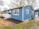 Charming blue home featuring fresh landscaping with healthy green lawn and sidewalk at 2814 S Randolph St, Indianapolis, IN 46203