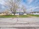 Charming blue one story home featuring freshly landscaped yard, a detached garage, and established trees at 2814 S Randolph St, Indianapolis, IN 46203