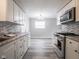 Bright kitchen view showcasing updated cabinets, appliances, backsplash, and flooring at 2814 S Randolph St, Indianapolis, IN 46203