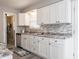 The kitchen boasts stainless steel appliances, modern white cabinets, and a stone backsplash at 2814 S Randolph St, Indianapolis, IN 46203