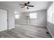 Spacious living room with modern gray flooring, ceiling fan, and updated white trim at 2814 S Randolph St, Indianapolis, IN 46203