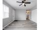 Bright living room with a ceiling fan, gray walls, and hardwood floors at 2814 S Randolph St, Indianapolis, IN 46203