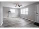 Bright living room with a ceiling fan, gray walls, and hardwood floors at 2814 S Randolph St, Indianapolis, IN 46203