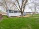 Landscaped yard with healthy green lawn and fresh mulch surrounding a charming blue and white home at 2814 S Randolph St, Indianapolis, IN 46203