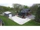 Overhead view showcases a grey house with a large concrete driveway next to a matching grey outbuilding at 301 Lowry St, Jamestown, IN 46147