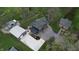 Stunning aerial view of a modern, gray home showcasing its expansive driveway and lush green surroundings at 301 Lowry St, Jamestown, IN 46147