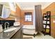 Bathroom features a vintage style tub, granite countertops, and a framed mirror with unique brick walls and decor at 301 Lowry St, Jamestown, IN 46147