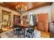 Dining room with a view into the kitchen features wood floors, vintage decor and brick accents at 301 Lowry St, Jamestown, IN 46147