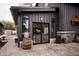 Stylish black home featuring large windows, a stone foundation, and a welcoming outdoor patio area at 301 Lowry St, Jamestown, IN 46147