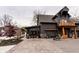 Modern gray home featuring a balcony, stone accents, spacious driveway, and beautiful landscaping at 301 Lowry St, Jamestown, IN 46147