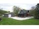Charming gray house featuring a large garage, an expansive driveway, and well-manicured lawn at 301 Lowry St, Jamestown, IN 46147
